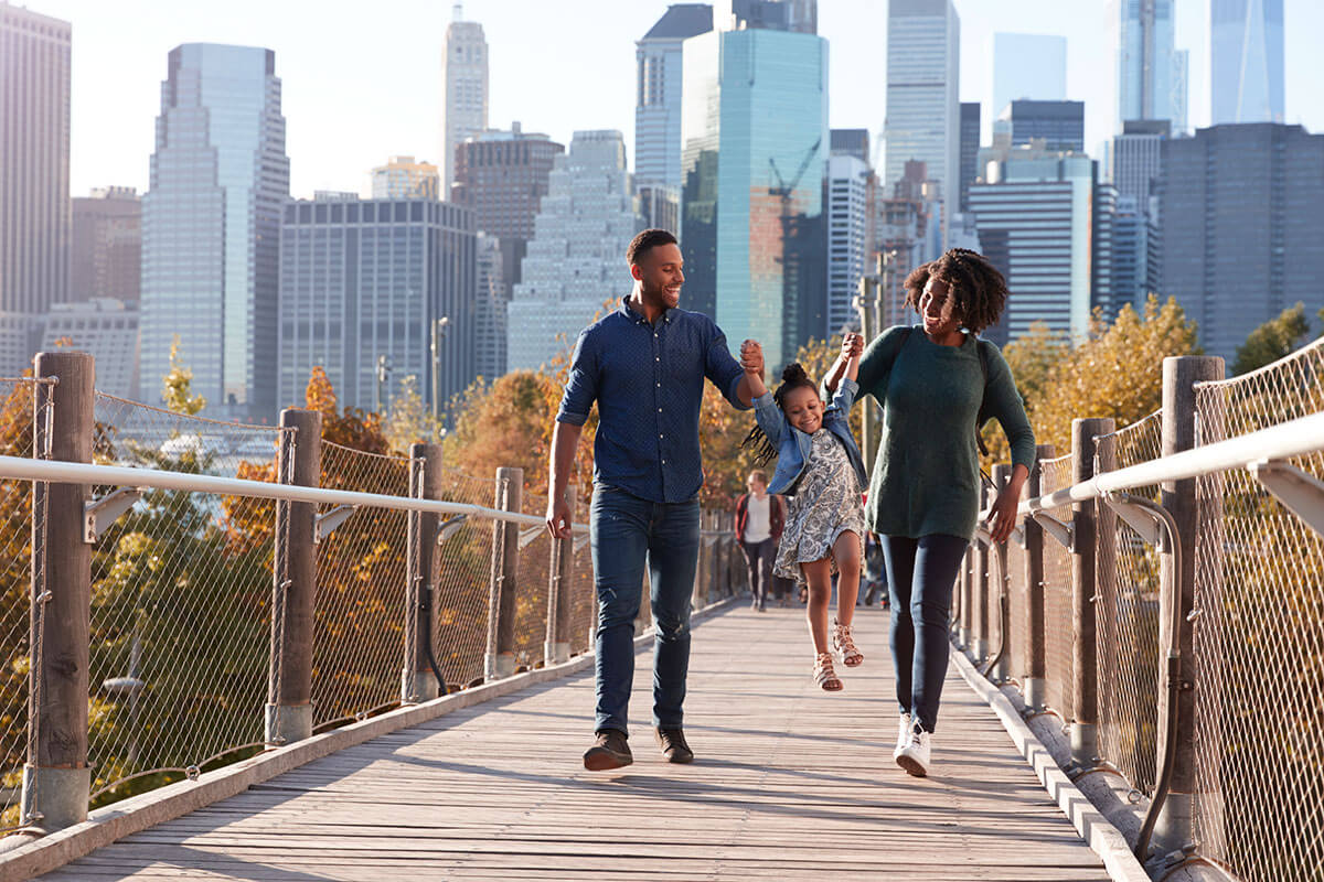 Family walking on city bridge